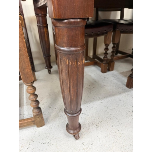 150 - A mahogany extendable dining table on turned legs and a set of six oak framed dining chairs with red... 