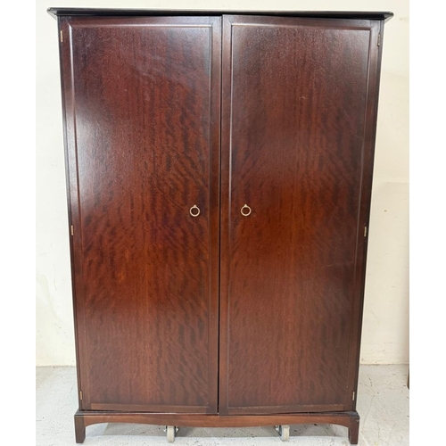 153 - A Stag two-door dark wood wardrobe with two internal cross rails and a single shelf H178cm W1126cm D... 