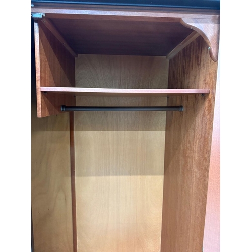 153 - A Stag two-door dark wood wardrobe with two internal cross rails and a single shelf H178cm W1126cm D... 