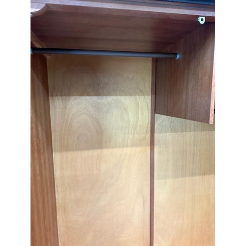 153 - A Stag two-door dark wood wardrobe with two internal cross rails and a single shelf H178cm W1126cm D... 