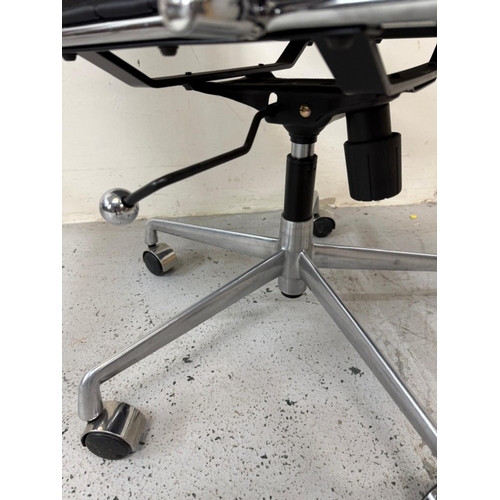 155 - A chrome and black faux leather office chair in the manner of Herman Miller Eames
