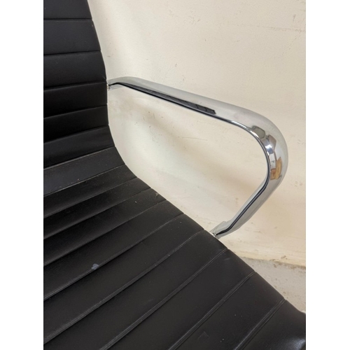 155 - A chrome and black faux leather office chair in the manner of Herman Miller Eames