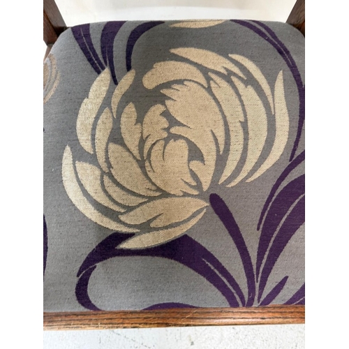 156 - An oak Arts and Crafts style open armchair with floral upholstery
