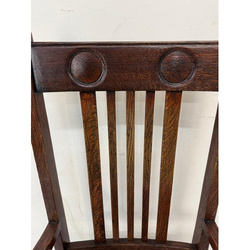 156 - An oak Arts and Crafts style open armchair with floral upholstery