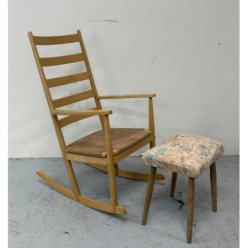 158 - A teak slat back rush seated rocking chair and footstool