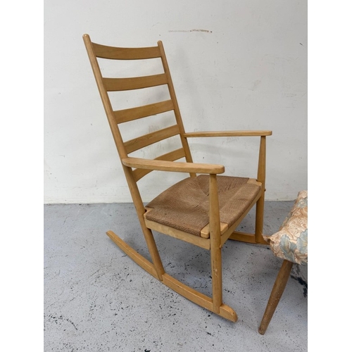 158 - A teak slat back rush seated rocking chair and footstool