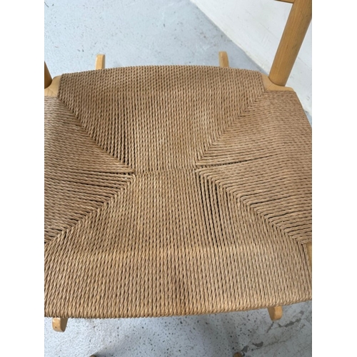 158 - A teak slat back rush seated rocking chair and footstool