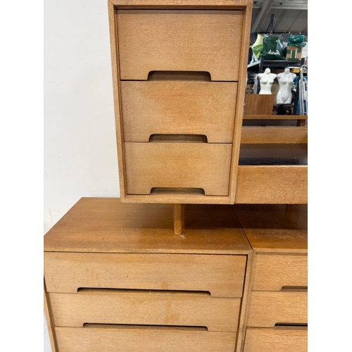161 - A Mid Century bedroom suite by Stag comprising of a wardrobe, two chest of drawers and a dressing ta... 