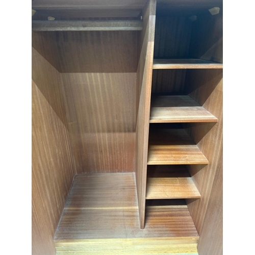 161 - A Mid Century bedroom suite by Stag comprising of a wardrobe, two chest of drawers and a dressing ta... 