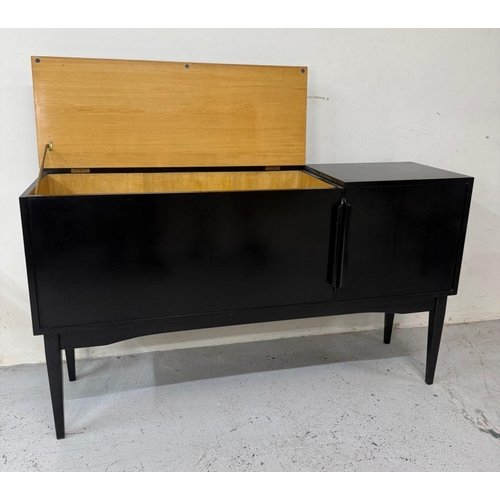 163 - A Mid Century ebonised record cabinet with hinged lid opening to storage and a single door cupboard ... 
