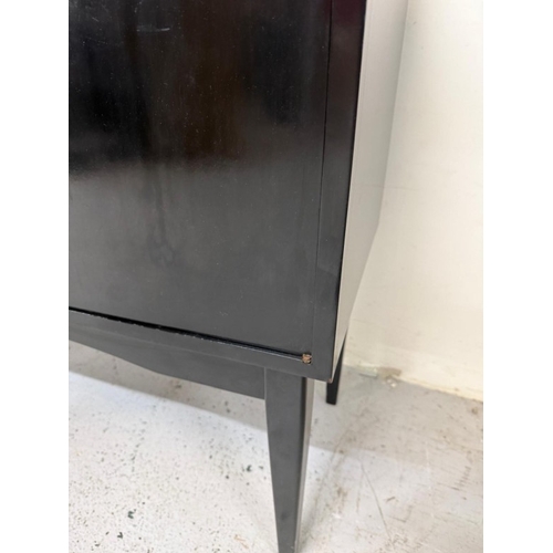 163 - A Mid Century ebonised record cabinet with hinged lid opening to storage and a single door cupboard ... 