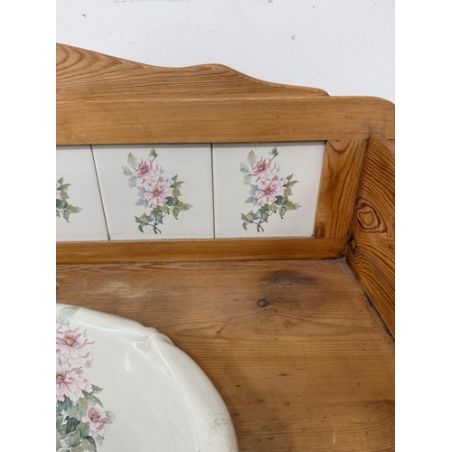 166 - A vintage pine wash stand with floral tiled back splash and sink with drawer and cupboard under H106... 