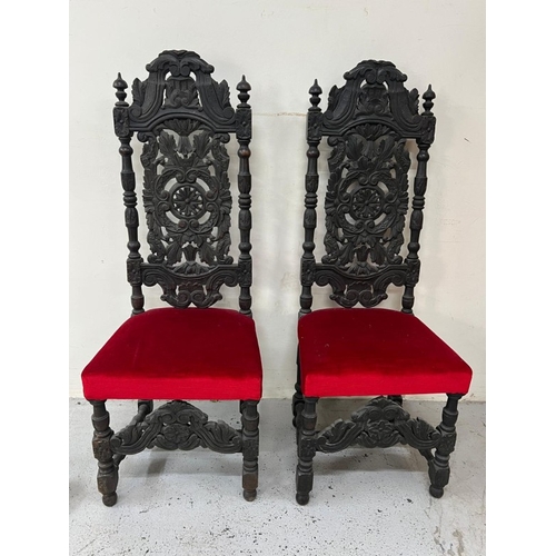 169 - A pair of Neo Renaissance style carved oak hall chairs