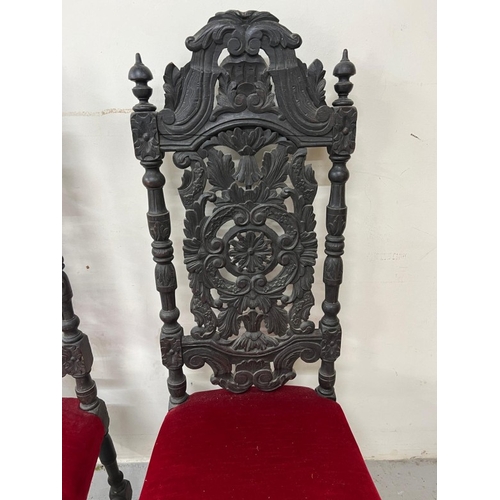 169 - A pair of Neo Renaissance style carved oak hall chairs