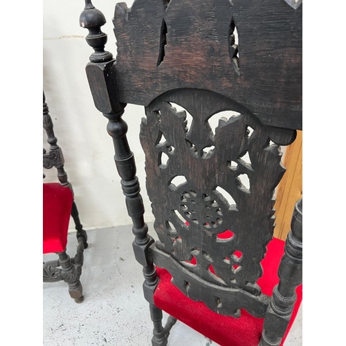 169 - A pair of Neo Renaissance style carved oak hall chairs