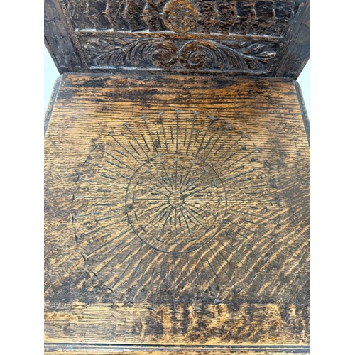 171 - An oak Jacobean-style hall chair with a heavily carved back ad on turned legs