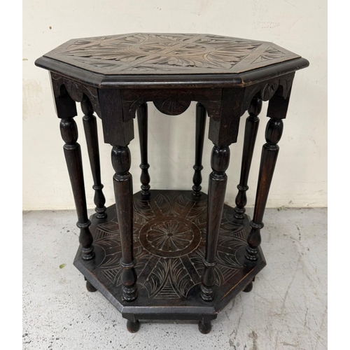 172 - An oak Anglo- Raj style octagonal table  with heavily foliate carvings, turned legs and shelf under ... 