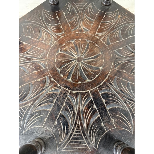 172 - An oak Anglo- Raj style octagonal table  with heavily foliate carvings, turned legs and shelf under ... 