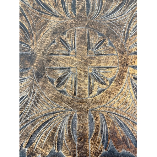 172 - An oak Anglo- Raj style octagonal table  with heavily foliate carvings, turned legs and shelf under ... 