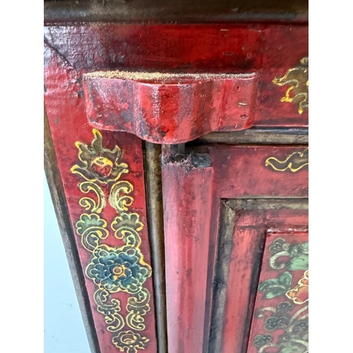 2 - A Chinese style hall cabinet with two cupboards, red grounds and decorated with green and gilt flowe... 