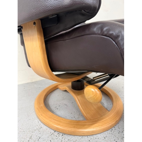 43 - A brown leather stressless reclining armchair and matching footstool
