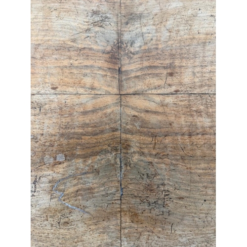 50 - A burr walnut inlaid oval centre table on carved outswept legs and with central finials H75cm W105cm... 