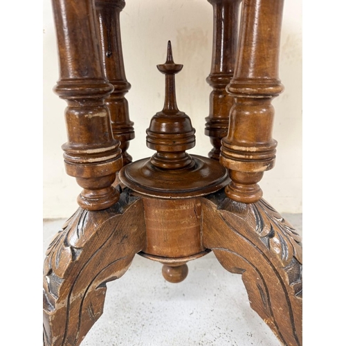 50 - A burr walnut inlaid oval centre table on carved outswept legs and with central finials H75cm W105cm... 