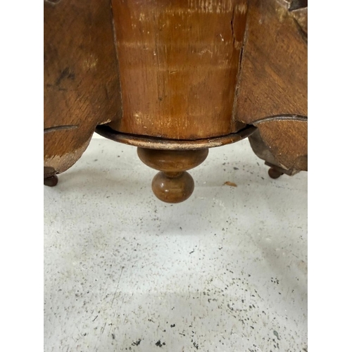 50 - A burr walnut inlaid oval centre table on carved outswept legs and with central finials H75cm W105cm... 