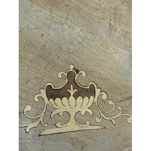 50 - A burr walnut inlaid oval centre table on carved outswept legs and with central finials H75cm W105cm... 