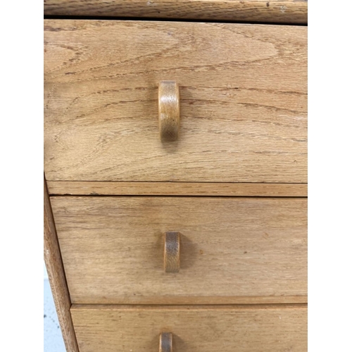 51 - A Mid Century light oak four drawer chest of drawers H77cm W60cm D38cm