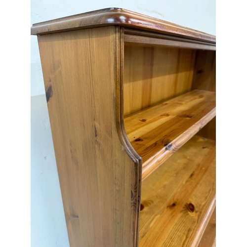 55 - A pine three-shelf waterfall bookcase H99cm W96cm D23cm