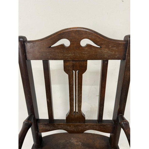 184 - An Edwardian oak metamorphic child's high chair converting to a play chair
