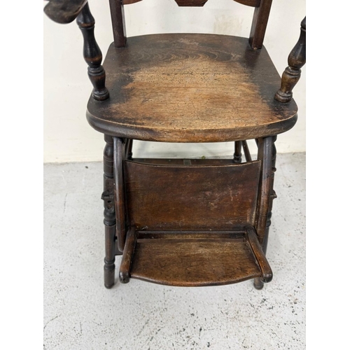 184 - An Edwardian oak metamorphic child's high chair converting to a play chair
