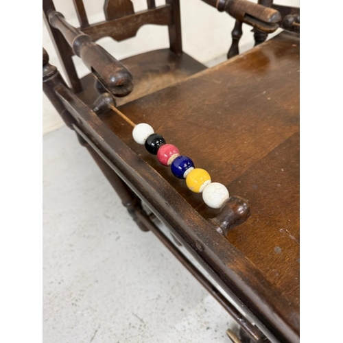 184 - An Edwardian oak metamorphic child's high chair converting to a play chair