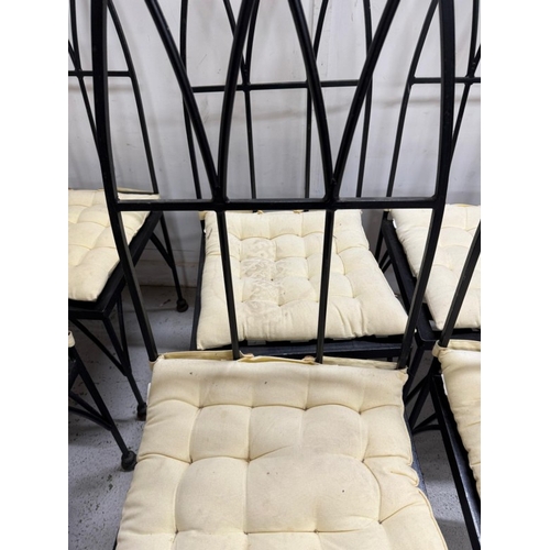 186 - A set of eight gothic revival wrought iron dinning chairs with arched backs an cream cushions. Heigh... 