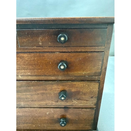 187 - An Apprentice piece or similar Chest of Drawers on bun feet with ebonised handles. Height 29.5cm x W... 