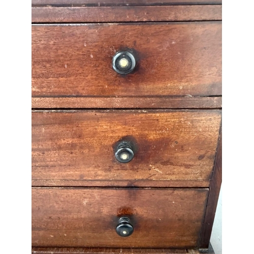 187 - An Apprentice piece or similar Chest of Drawers on bun feet with ebonised handles. Height 29.5cm x W... 