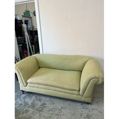 188 - Two seater sofa with drop sides in lime H69cm W164cm D88cm