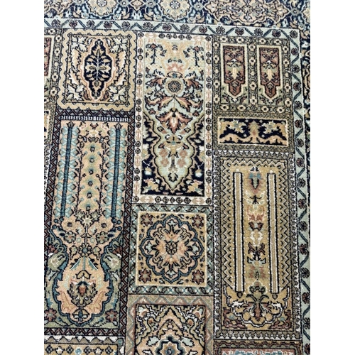 190 - A wool rug with beige ground and a geometric border 160cm x 93cm