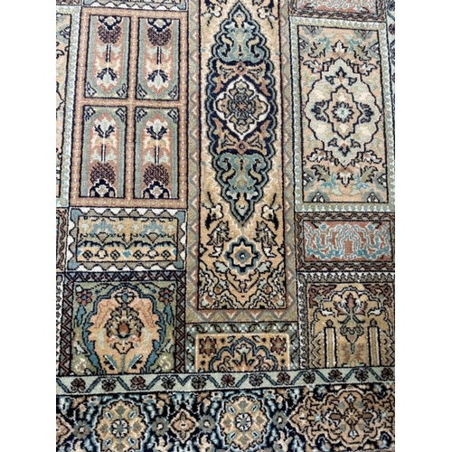 190 - A wool rug with beige ground and a geometric border 160cm x 93cm