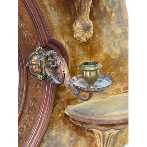 198 - A circular bevel-edged overmantel mirror, the surrounding frame upholstered in mustard yellow velvet... 