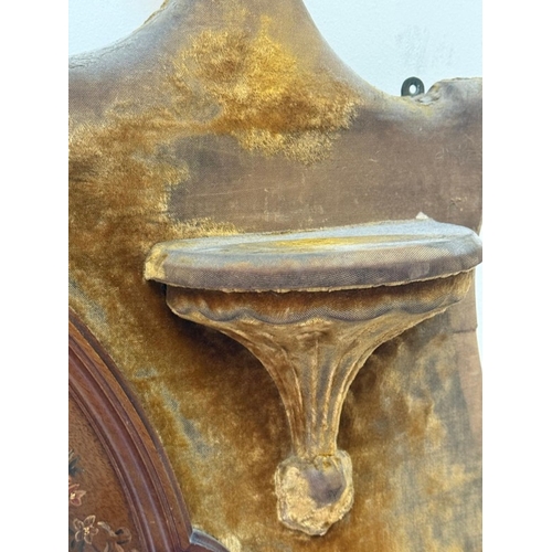198 - A circular bevel-edged overmantel mirror, the surrounding frame upholstered in mustard yellow velvet... 