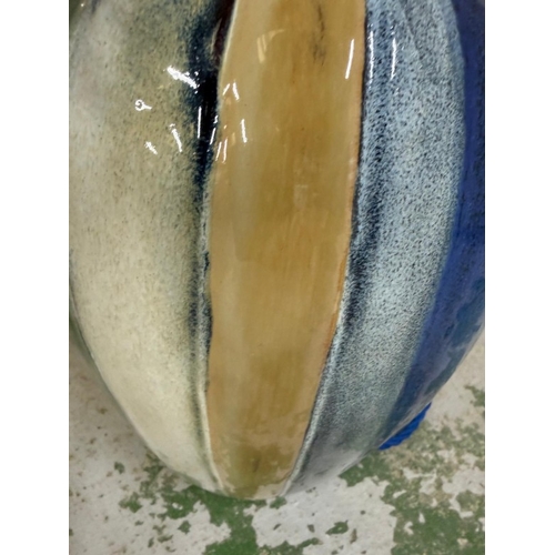 207 - A glazed ceramic table lamp in grey, blue, cream and green stripes. Height 52cm