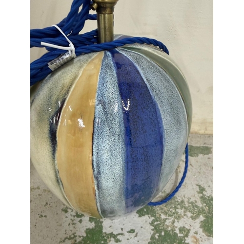 207 - A glazed ceramic table lamp in grey, blue, cream and green stripes. Height 52cm