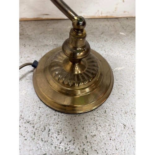 208 - A brass bankers lamp with green glass shade Height 35cm.