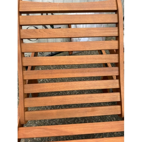 231 - A pair of John Lewis sun loungers with a side table