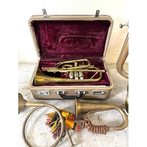 235 - A collection of brass musical instruments to include a Tuba and a boxed horn