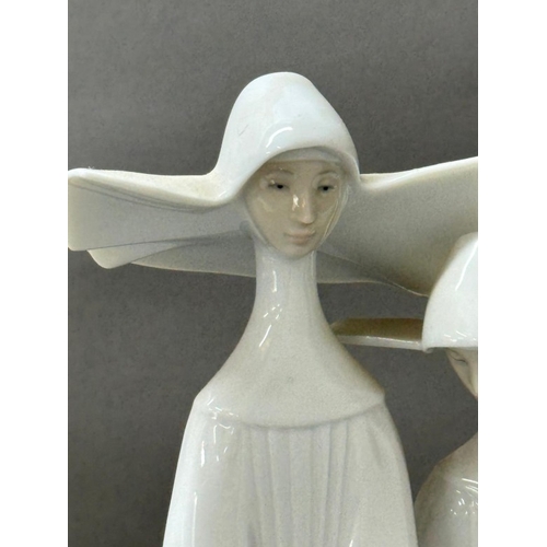 255 - Lladro figure of two nuns, approximate height 33cm.