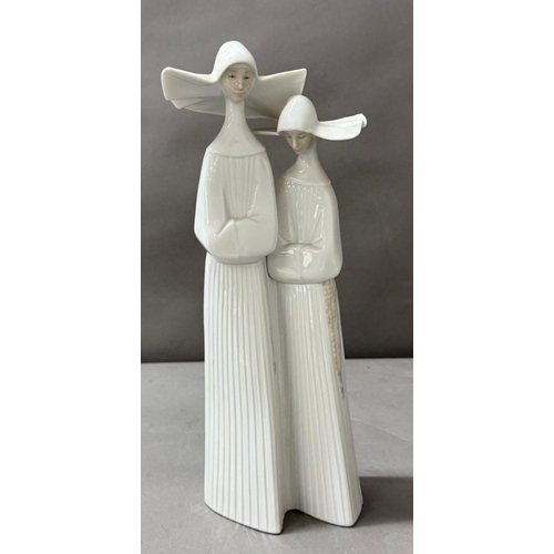 255 - Lladro figure of two nuns, approximate height 33cm.