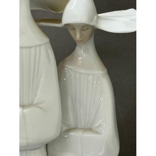 255 - Lladro figure of two nuns, approximate height 33cm.